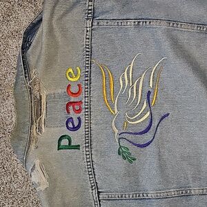 A '90s era size extra large Levi trucker denim jacket with custom embroidery